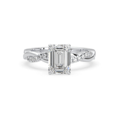 Emerald brilliant lab grown diamond engagement ring with prong setting and twisted pavé diamond band in white gold tone