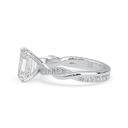 Emerald brilliant lab grown diamond engagement ring with prong setting and twisted pavé diamond band in white gold tone