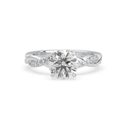 Round brilliant lab grown diamond engagement ring with prong setting and twisted pavé diamond band in white gold tone