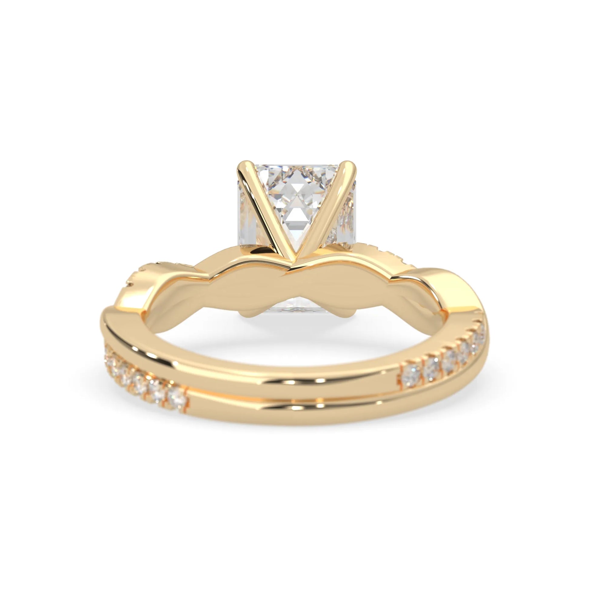 Emerald brilliant lab grown diamond engagement ring with prong setting and twisted pavé diamond band in yellow gold tone