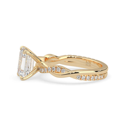 Emerald brilliant lab grown diamond engagement ring with prong setting and twisted pavé diamond band in yellow gold tone