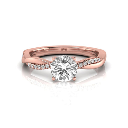Round cut lab grown diamond engagement ring featuring a twisted pavé shank with a four-prong solitaire setting and polished rose gold tone band.