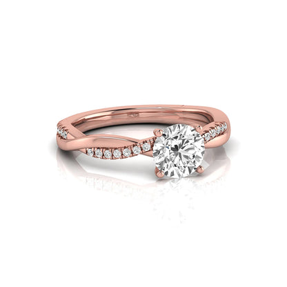 Round cut lab grown diamond engagement ring featuring a twisted pavé shank with a four-prong solitaire setting and polished rose gold tone band.