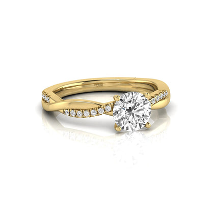 Round cut lab grown diamond engagement ring featuring a twisted pavé shank with a four-prong solitaire setting and polished yellow gold tone band.