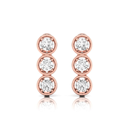 Three stone round cut lab grown diamond hoop earrings featuring bezel-inspired four prong settings, vertical diamond arrangement, hinged snap closure, and rose gold tone.