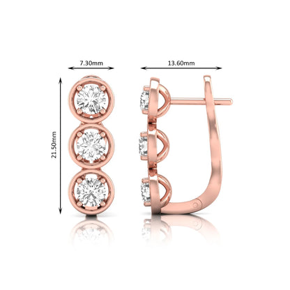 Three stone round cut lab grown diamond hoop earrings featuring bezel-inspired four prong settings, vertical diamond arrangement, hinged snap closure, and rose gold tone.