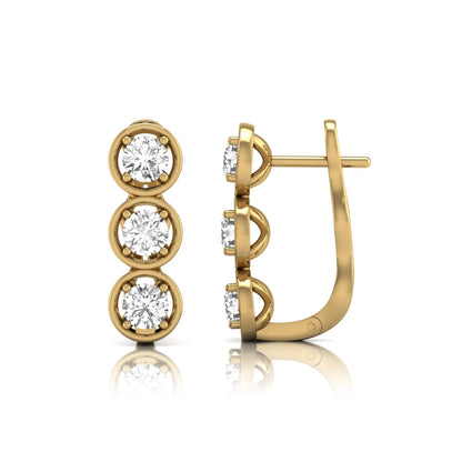 Three stone round cut lab grown diamond hoop earrings featuring bezel-inspired four prong settings, vertical diamond arrangement, hinged snap closure, and yellow gold tone.