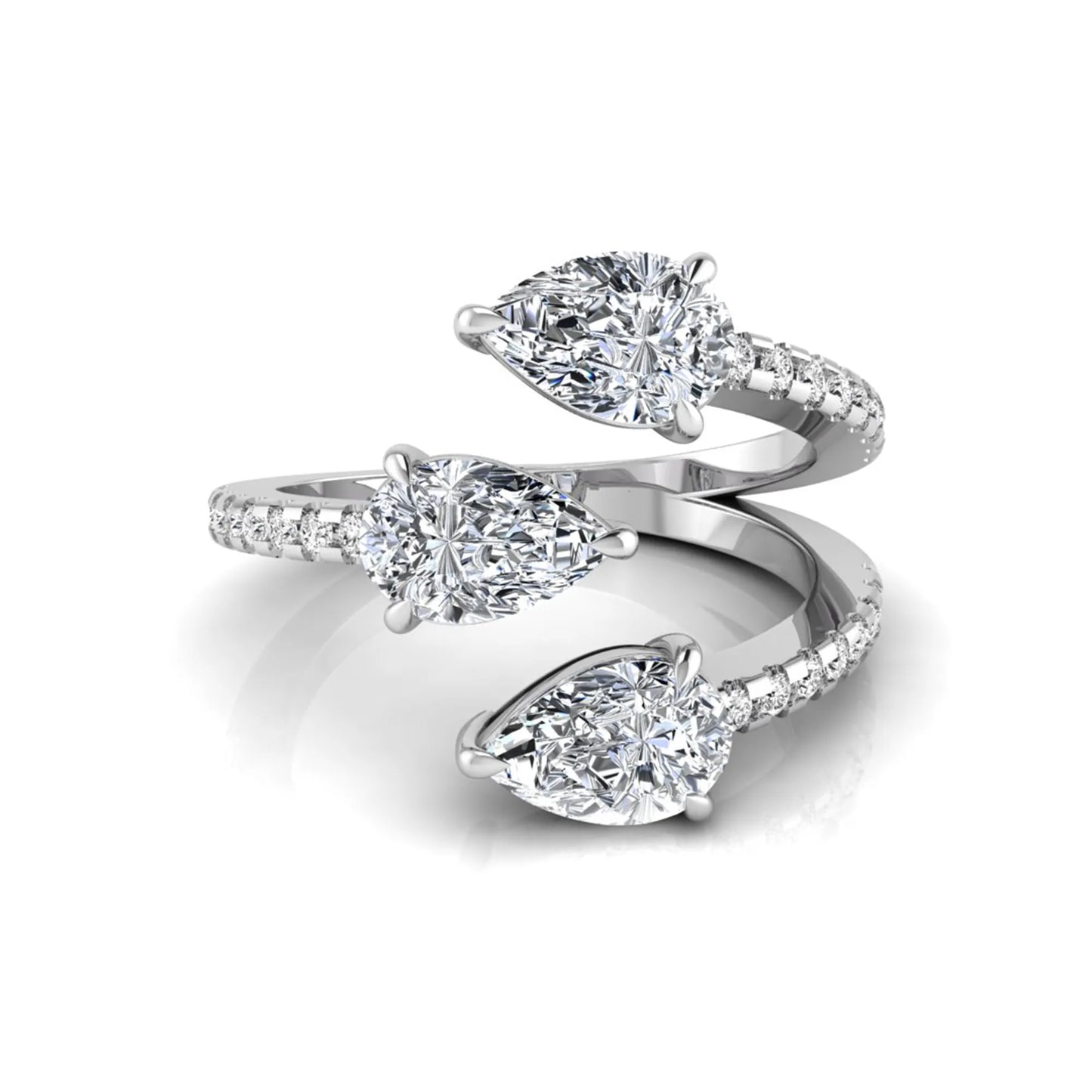 Three stone pear cut lab grown diamond wrap ring featuring round diamond accents and pavé shoulders in polished white gold.