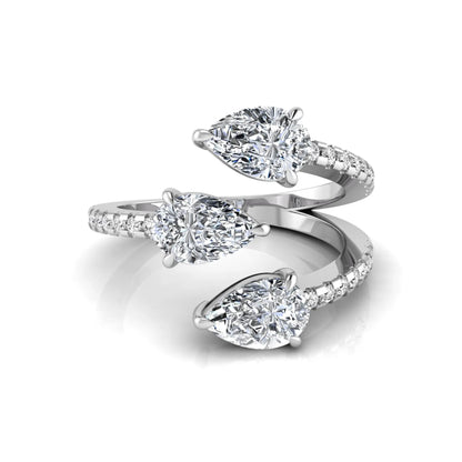 Three stone pear cut lab grown diamond wrap ring featuring round diamond accents and pavé shoulders in polished white gold.