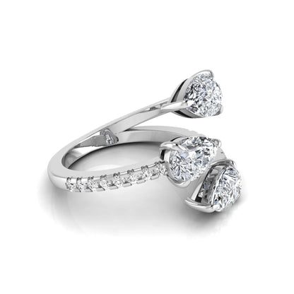 Three stone pear cut lab grown diamond wrap ring featuring round diamond accents and pavé shoulders in polished white gold.