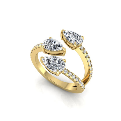 Three stone pear cut lab grown diamond wrap ring featuring round diamond accents and pavé shoulders in polished yellow gold.