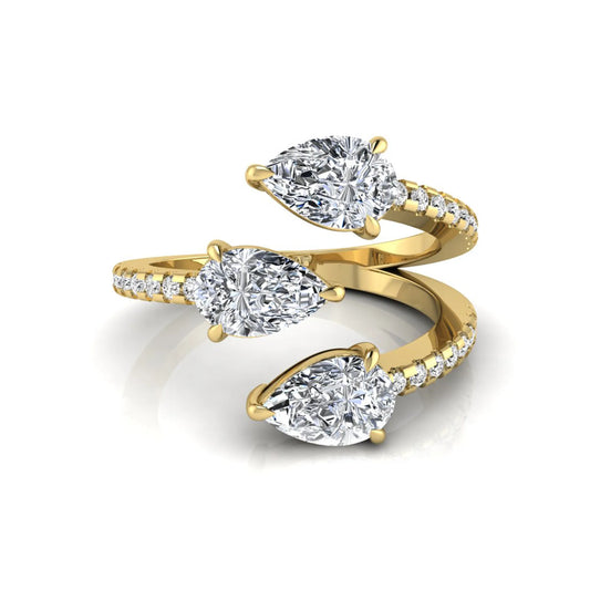 Three stone pear cut lab grown diamond wrap ring featuring round diamond accents and pavé shoulders in polished yellow gold.