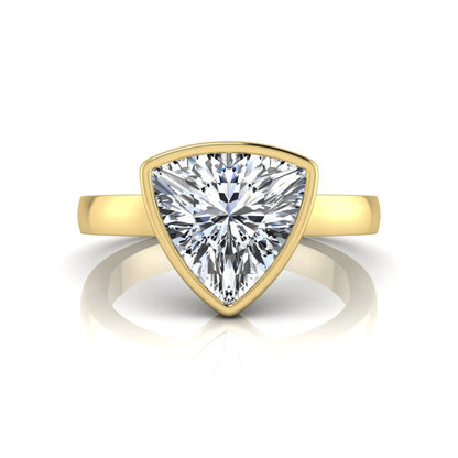 Trillion cut lab grown diamond bezel solitaire engagement ring in yellow gold with IGI certified center diamond.