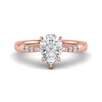 Vintage pear cut lab grown diamond engagement ring featuring an IGI certified center diamond, round diamond accents, and an ornate scroll gallery in rose gold.