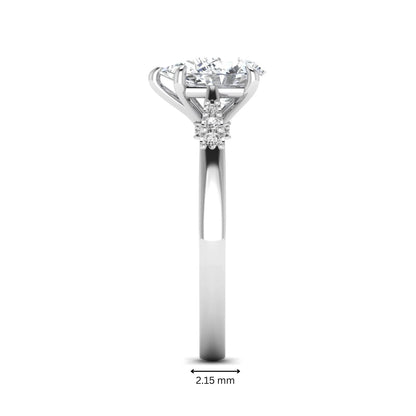 Vintage pear cut lab grown diamond engagement ring featuring an IGI certified center diamond, round diamond accents, and an ornate scroll gallery in white gold.