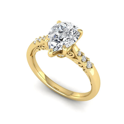 Vintage pear cut lab grown diamond engagement ring featuring an IGI certified center diamond, round diamond accents, and an ornate scroll gallery in yellow gold.